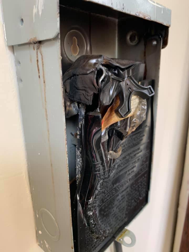 AC condenser fan motor and blade assembly viewed from above — inspected and serviced as part of a Highland Lakes Heating & Air AC tune-up
